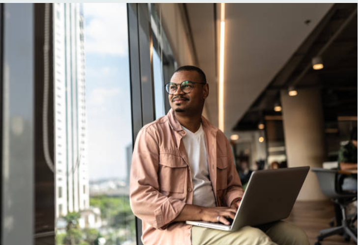African professional preparing with a laptop
